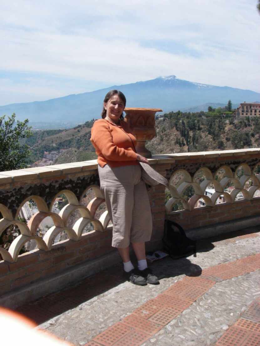 Part-time Addison resident Teresa Wilkin, shown here in front of active volcano Mount Aetna...