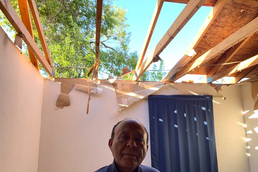 Gizaw Gedlu, 71, stands in his Richardson home that was destroyed by a tornado Sunday night.