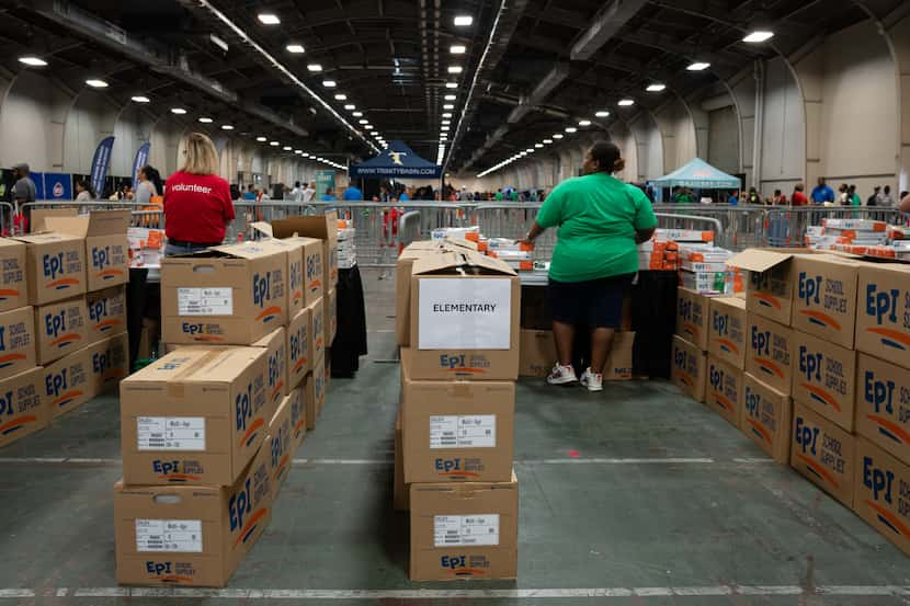 Volunteers with Target prepare to hand out school supplies at the Mayor's Back to School...