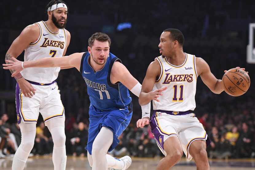 Dallas Mavericks guard Luka Doncic (77) defends Los Angeles Lakers guard Avery Bradley (11)...