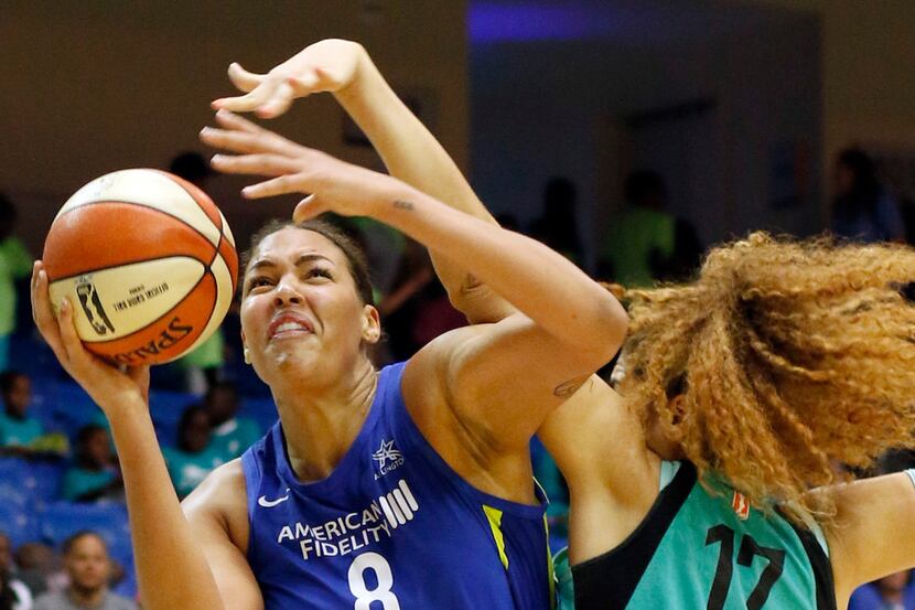 Dallas Wings center Liz Cambage (8) drives past the defense of New York Liberty center...