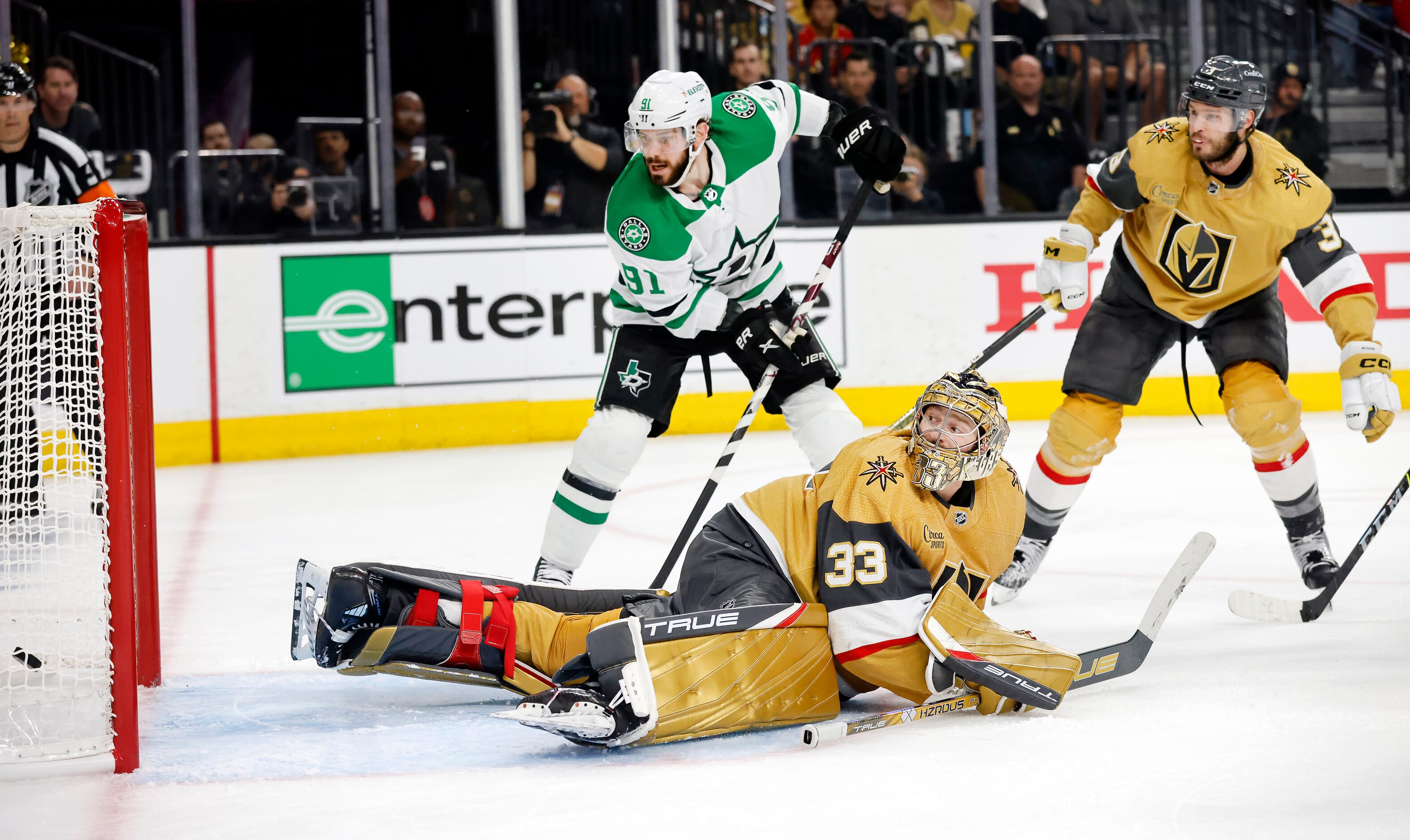 Vegas Golden Knights goaltender Adin Hill (33) looks back at the puck as Dallas Stars left...