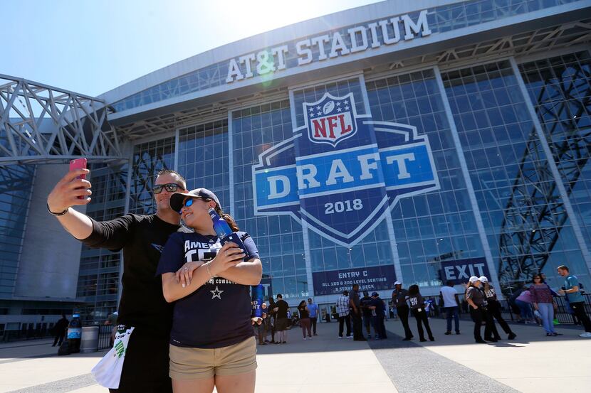 Dallas Cowboys fans Kevin Gass, left, and his girlfriend Natasha Weston take a selfie with a...