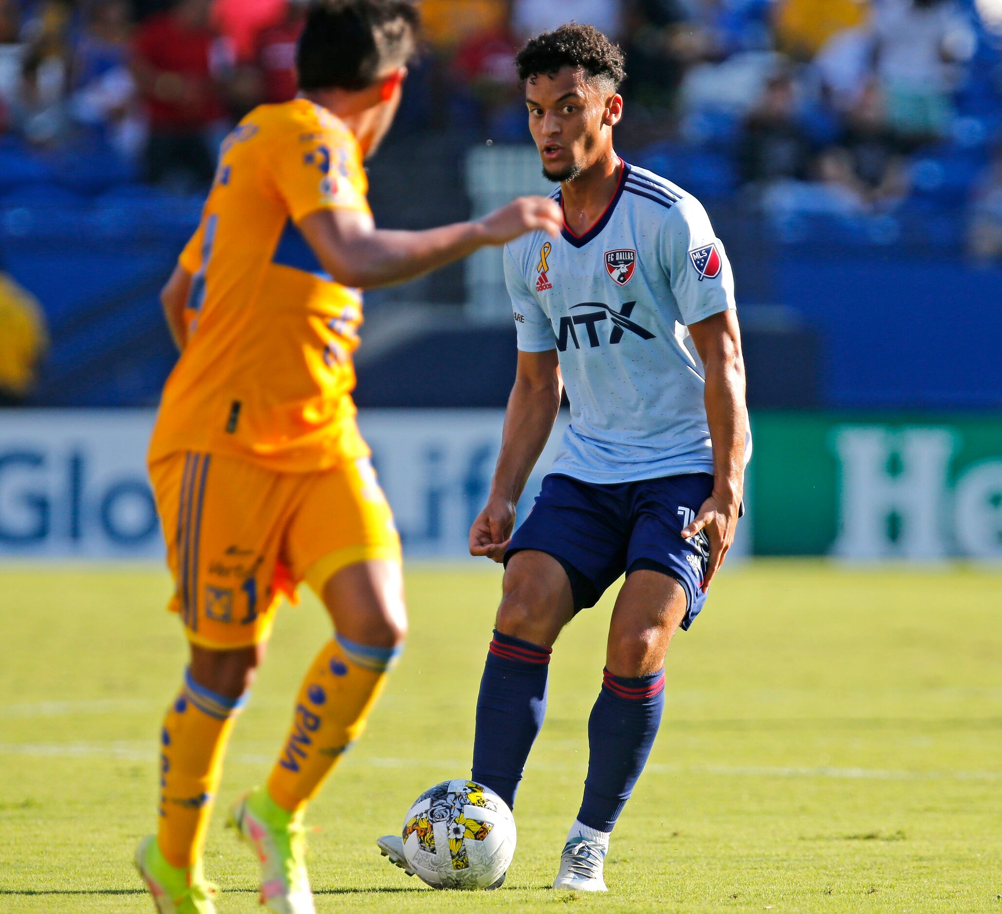 FC Dallas midfielder Brandon Servania (18) makes a pass by Tigres UANL defender Jesus Garza...