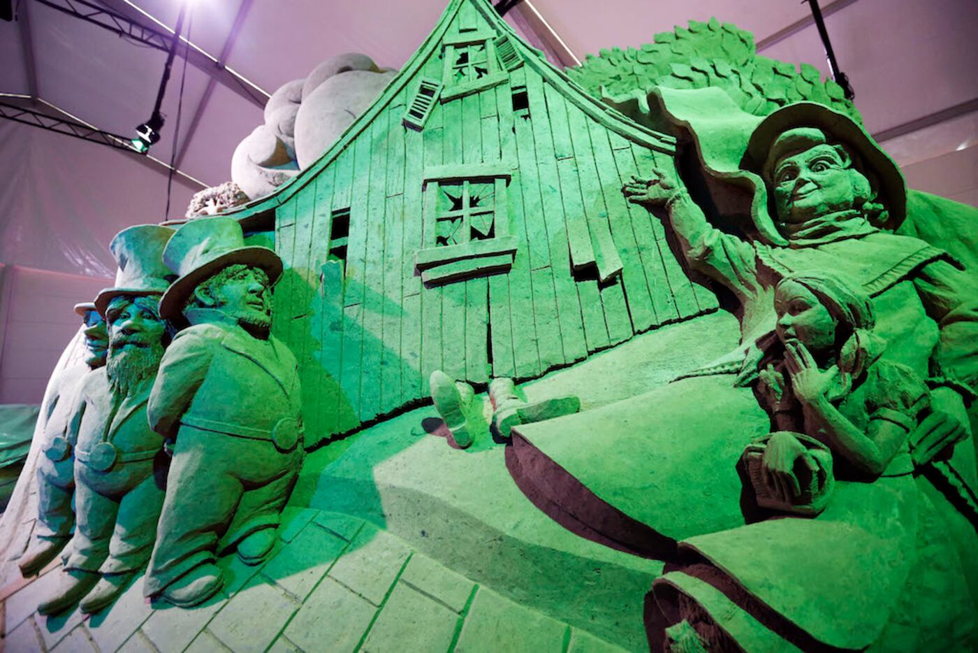A sand sculpture depicting Dorothy's house landing on the Wicked Witch of the East