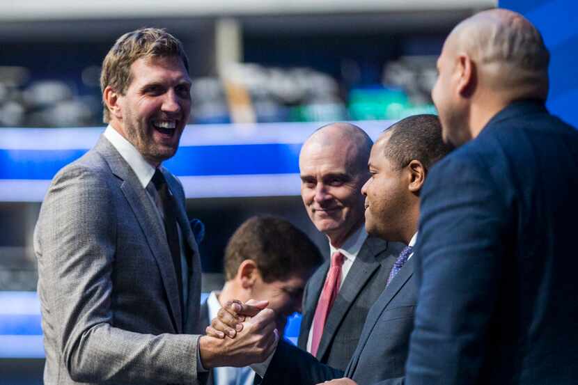 Retired Dallas Mavericks player Dirk Nowitzki (left) shakes hands with Dallas Mayor Eric...