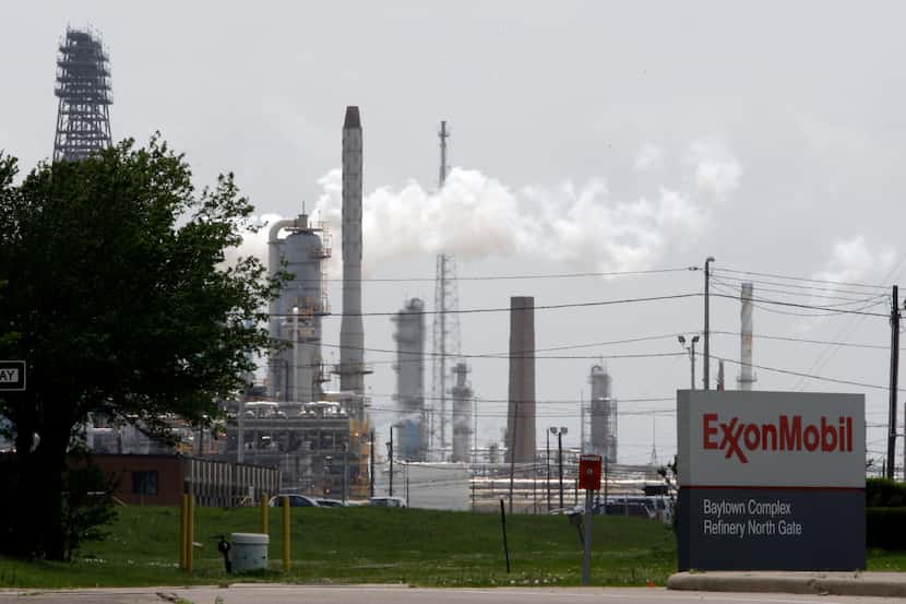 In this April 16, 2010 photo, steam rises from towers at an Exxon Mobil refinery in Baytown,...