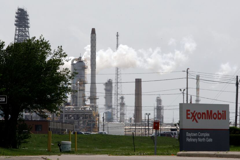 ORG XMIT: TXPS102 In this April 16, 2010 photo, steam rises from towers at an Exxon Mobil...
