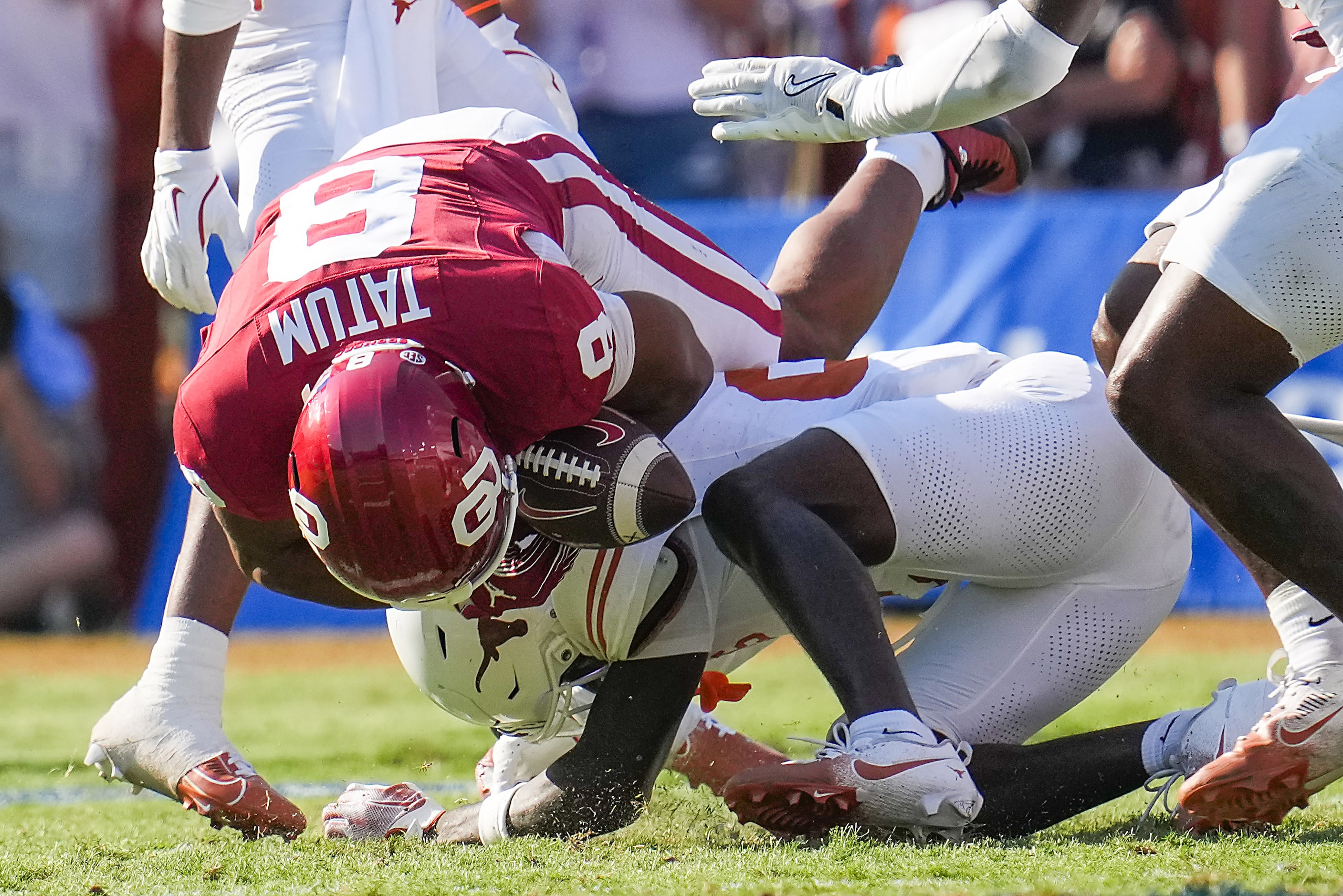 Oklahoma running back Taylor Tatum (8) fumbles as he is hit by Texas’ Derek Williams Jr....