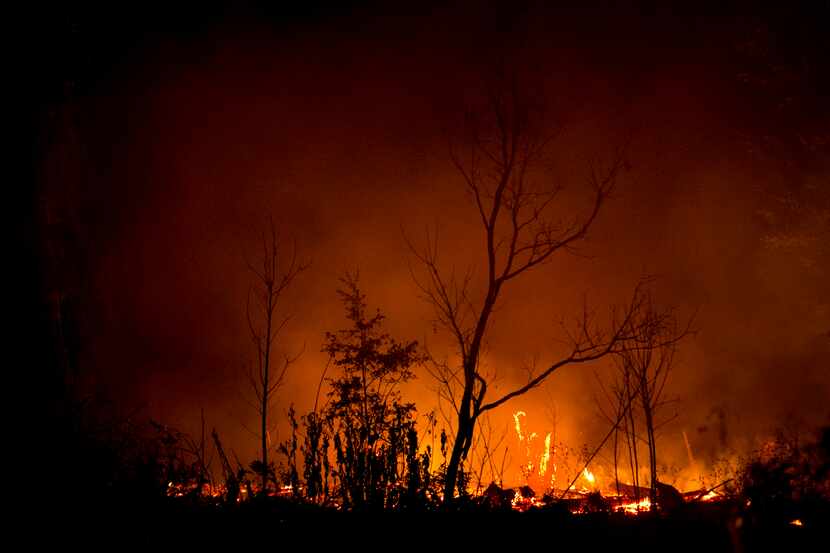 The Hidden Pines fire burns near Bastrop, Texas, on Thursday night, Oct. 15, 2015.