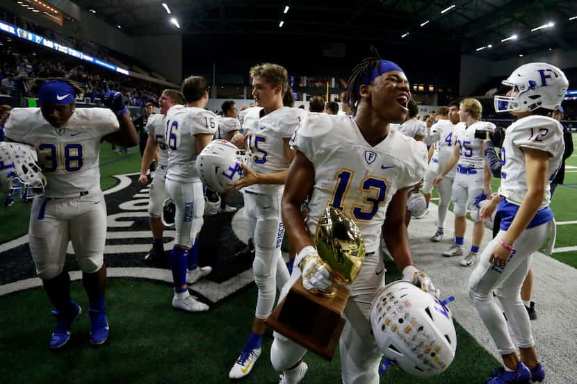 Frisco's Blake May (13) and teammates celebrate after their 18-0 win in a high school...