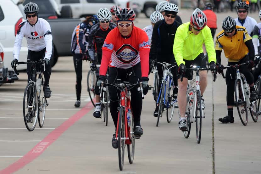 Cyclists begin their biking tour of Plano at the rear of a shopping center on Coit Rd in...