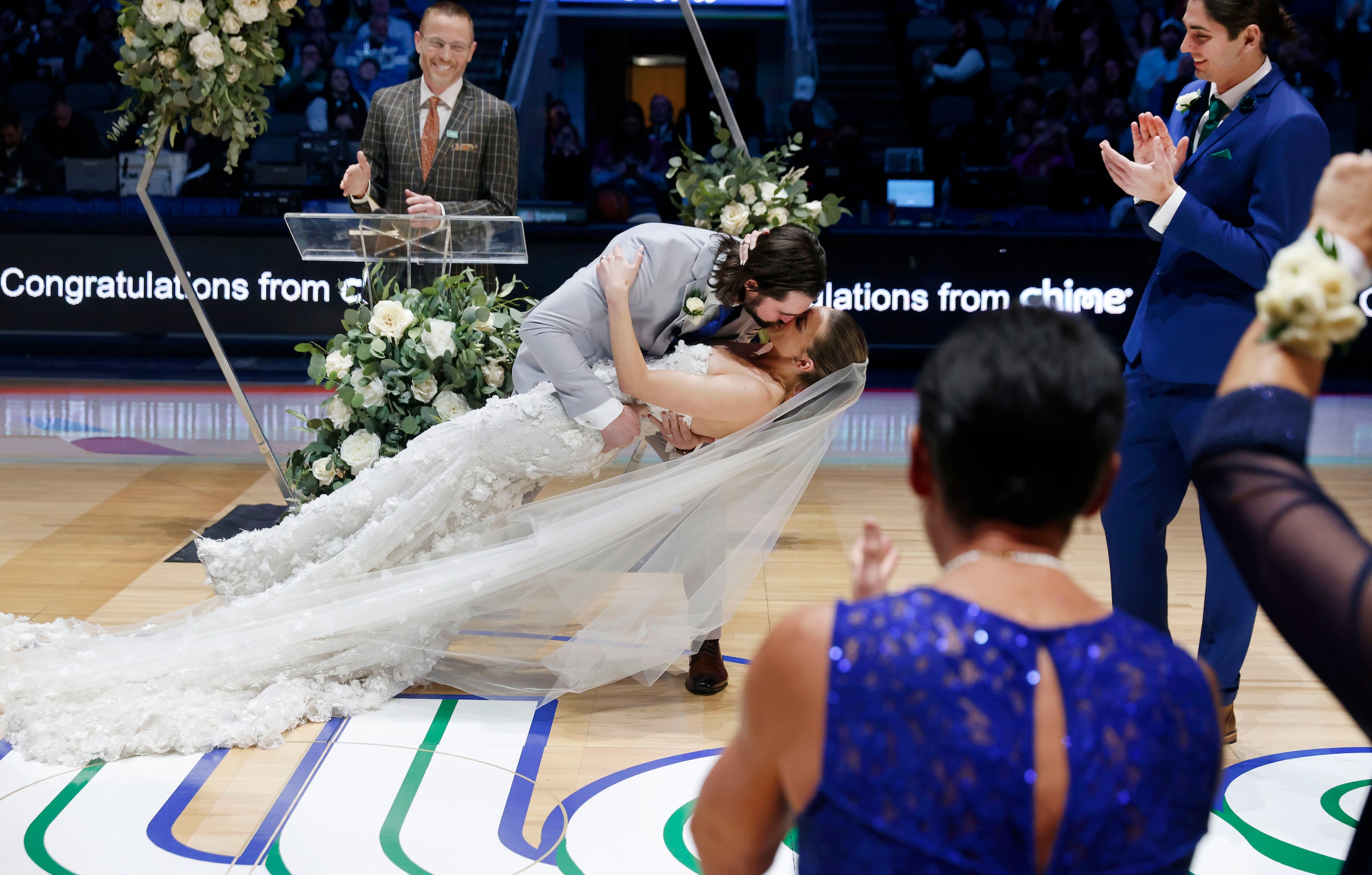 Reid Malone dips his bride Ellyn Nichole Piatt after they were wed at halftime of the Dallas...