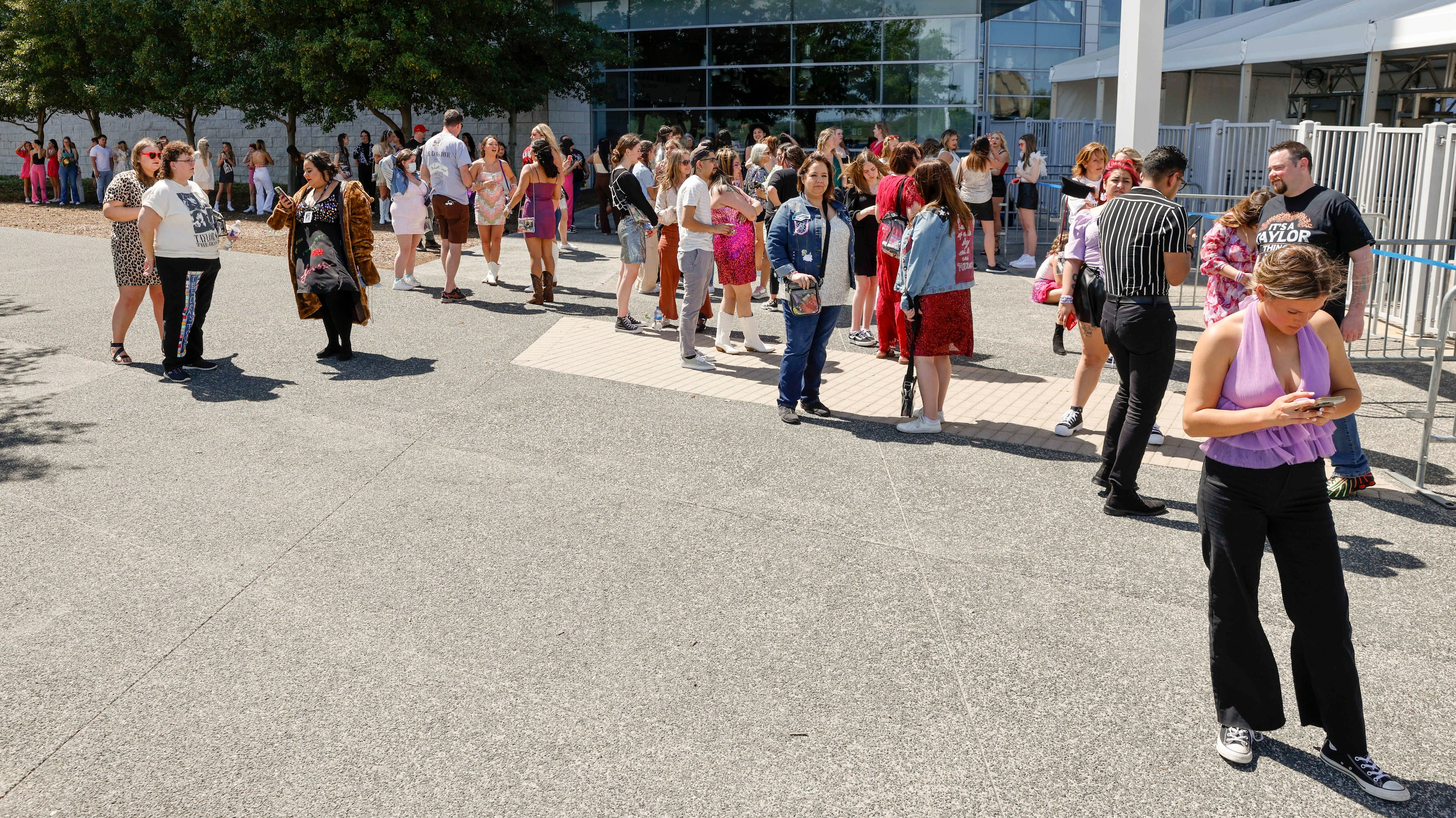 Fans wait for doors to open before a Taylor Swift Eras Tour concert at AT&T Stadium.