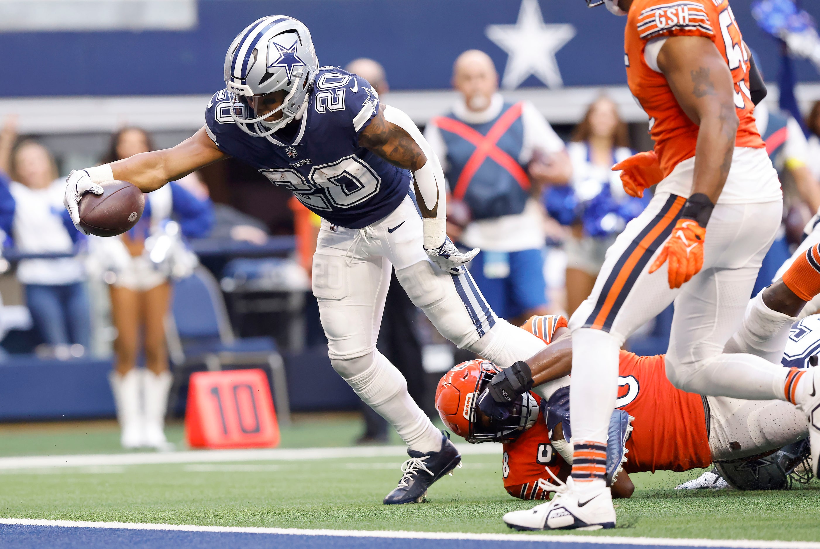 Dallas Cowboys running back Tony Pollard (20) reaches across the goal line for a third...