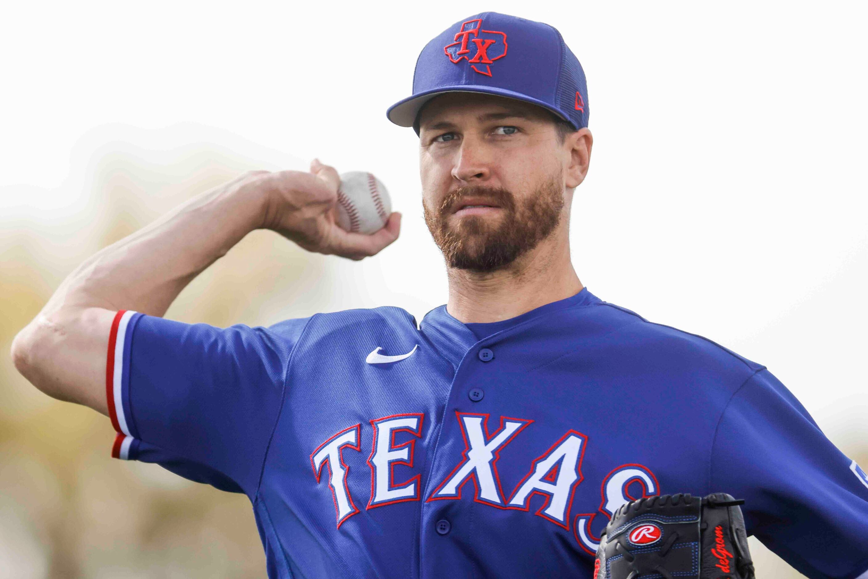 Texas Rangers pitcher Jacob deGrom throws a pitch during a spring training workout at the...