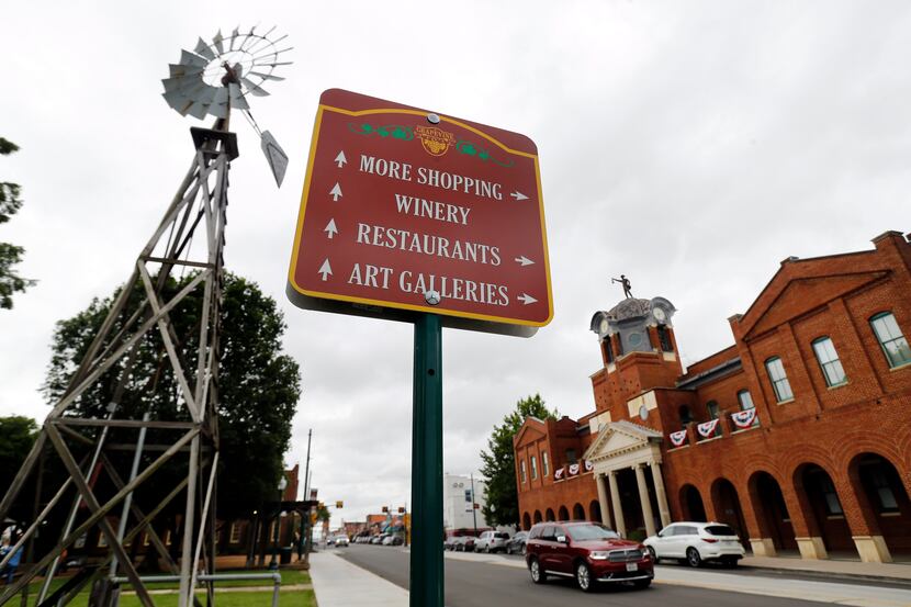 A sign gives directions to tourists visiting historic Grapevine, Texas, Tuesday, June 23,...