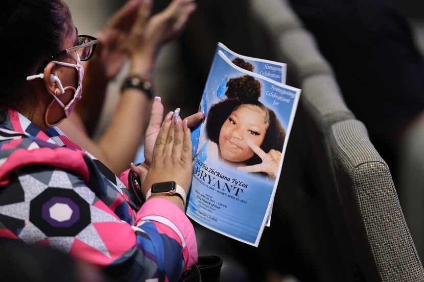 A mourner holds a funeral program during services for 16-year-old Ma'Khia Bryant at First...