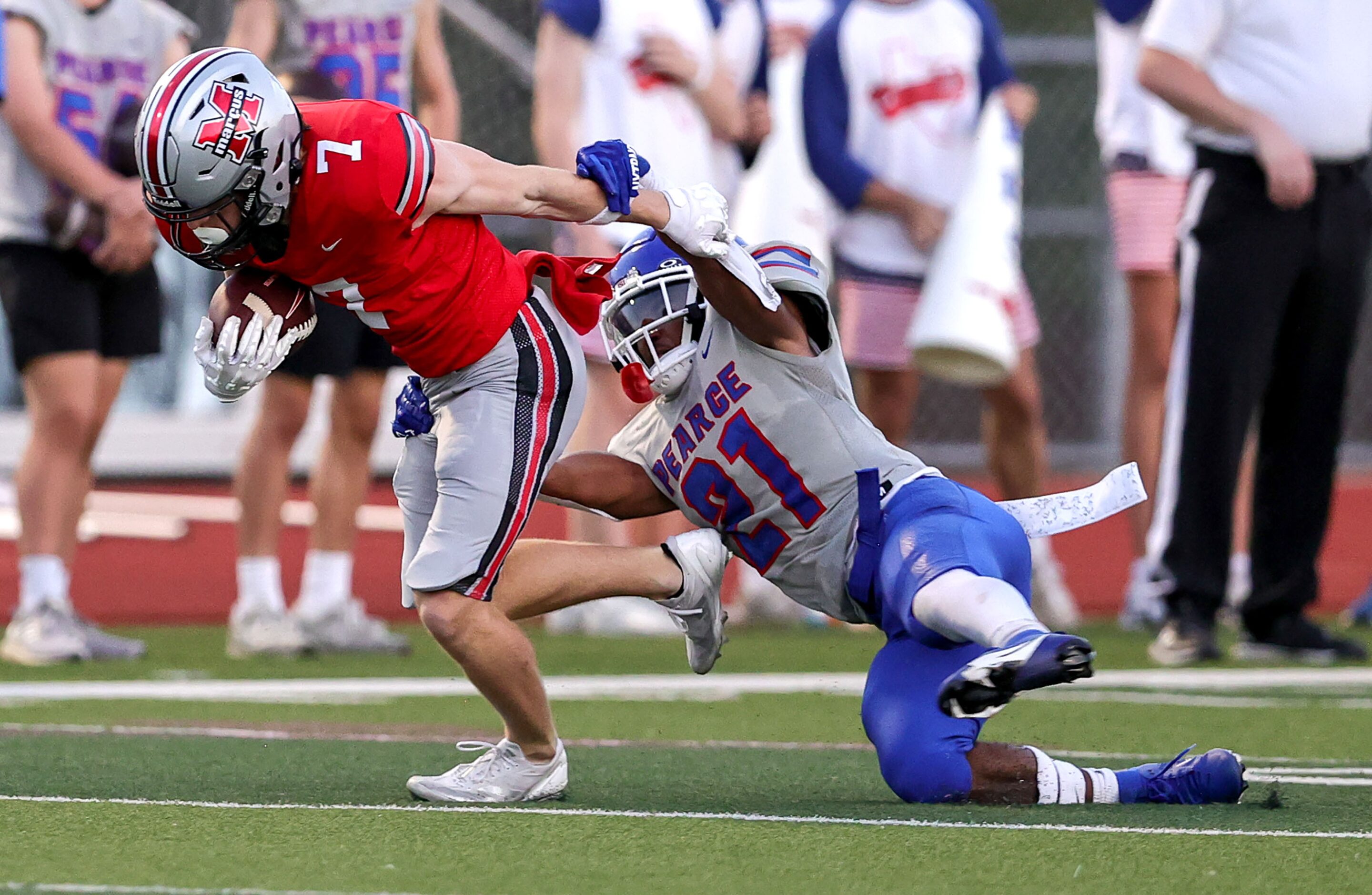 Flower Mound Marcus wide receiver Cooper Campbell (7) tries to break a tackle from...