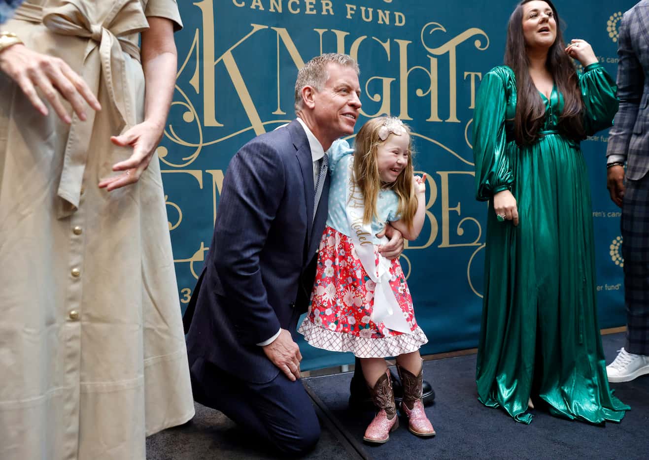 Former Dallas Cowboys quarterback Troy Aikman poses for a photo with seven yr-old model Cami...