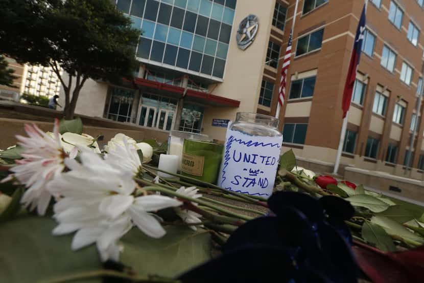 Flowers were placed at a memorial at Jack Evans Police Headquarters in Dallas on Friday.
