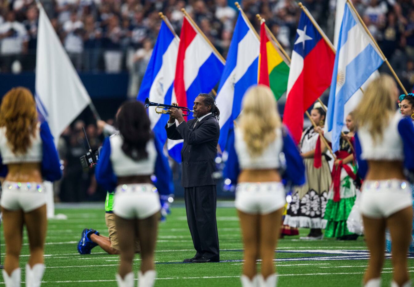 Trumpet player Freddie Jones, shown playing the national anthem at Sunday's Cowboys-Rams...