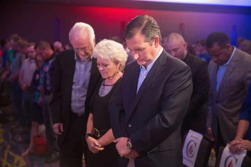 Sen. Ted Cruz bows head to pray before the start of his Religious Liberty Rally on August...