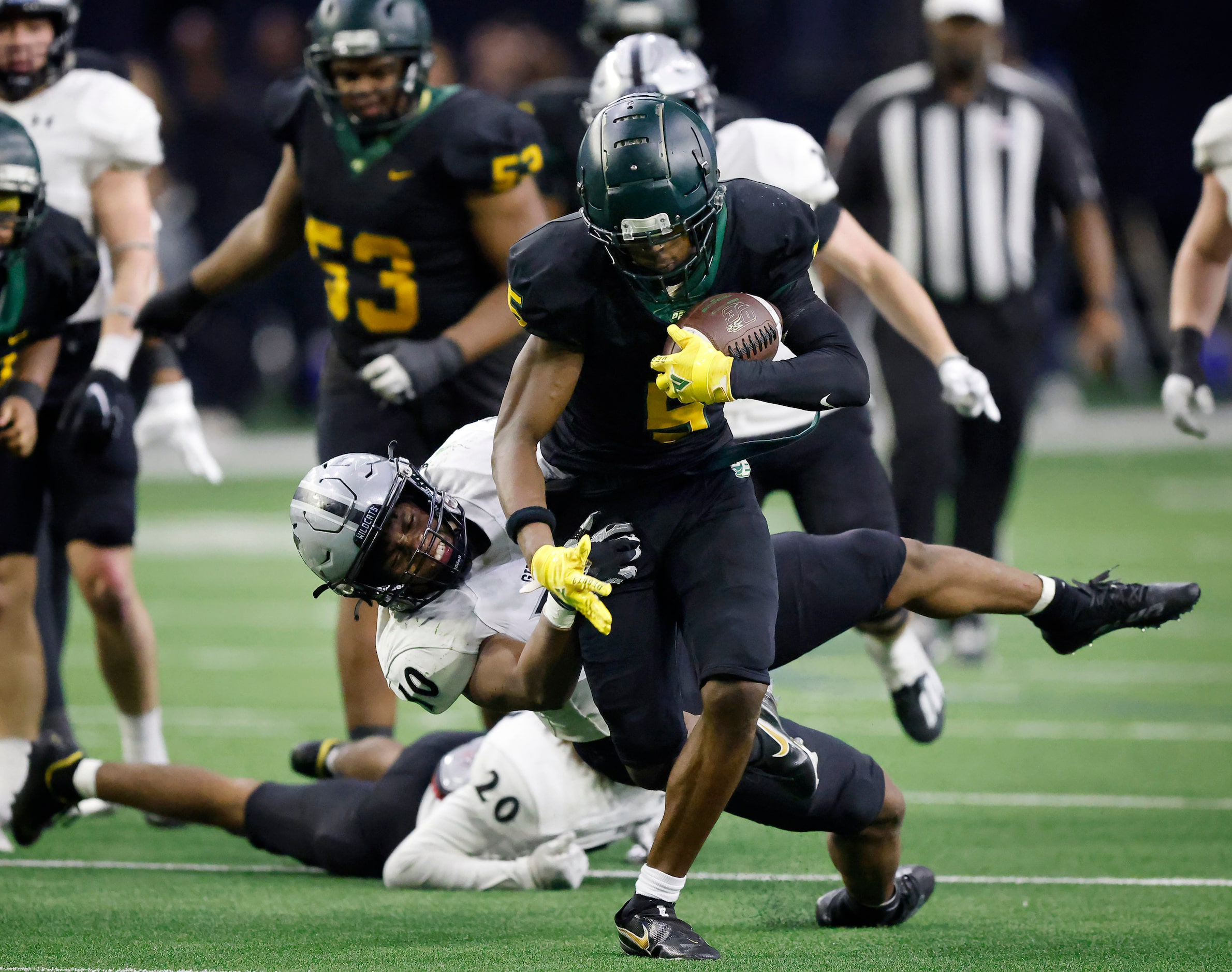 DeSoto running back Tre Wisner (5) is tackled by Denton Guyer linebacker Caleb Darthard (10)...