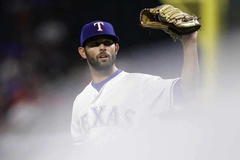 ARLINGTON, TX - JULY 26:  Nick Martinez #22 of the Texas Rangers steps off the mound after...