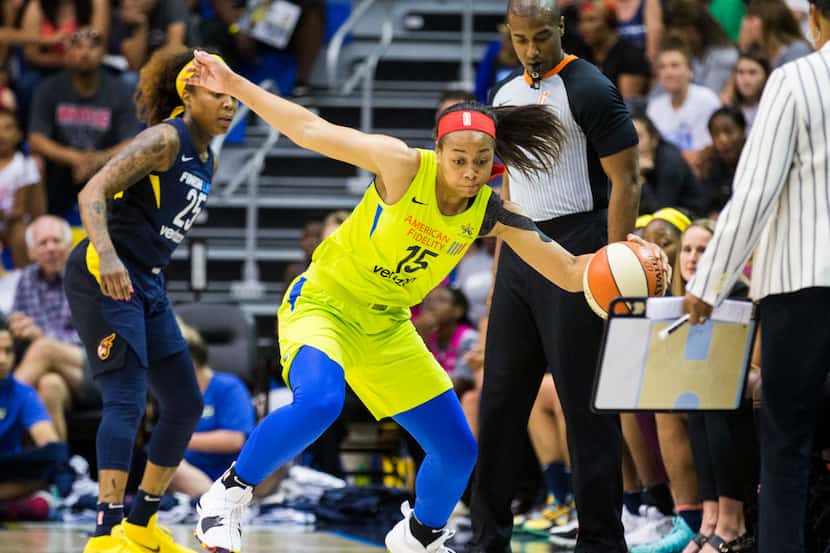 Dallas Wings guard Allisha Gray (15) keeps the ball in play during the first quarter of a...