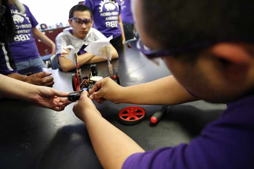 Senior Hector Ortiz puts together a robot during an after-school robotics team meeting for...