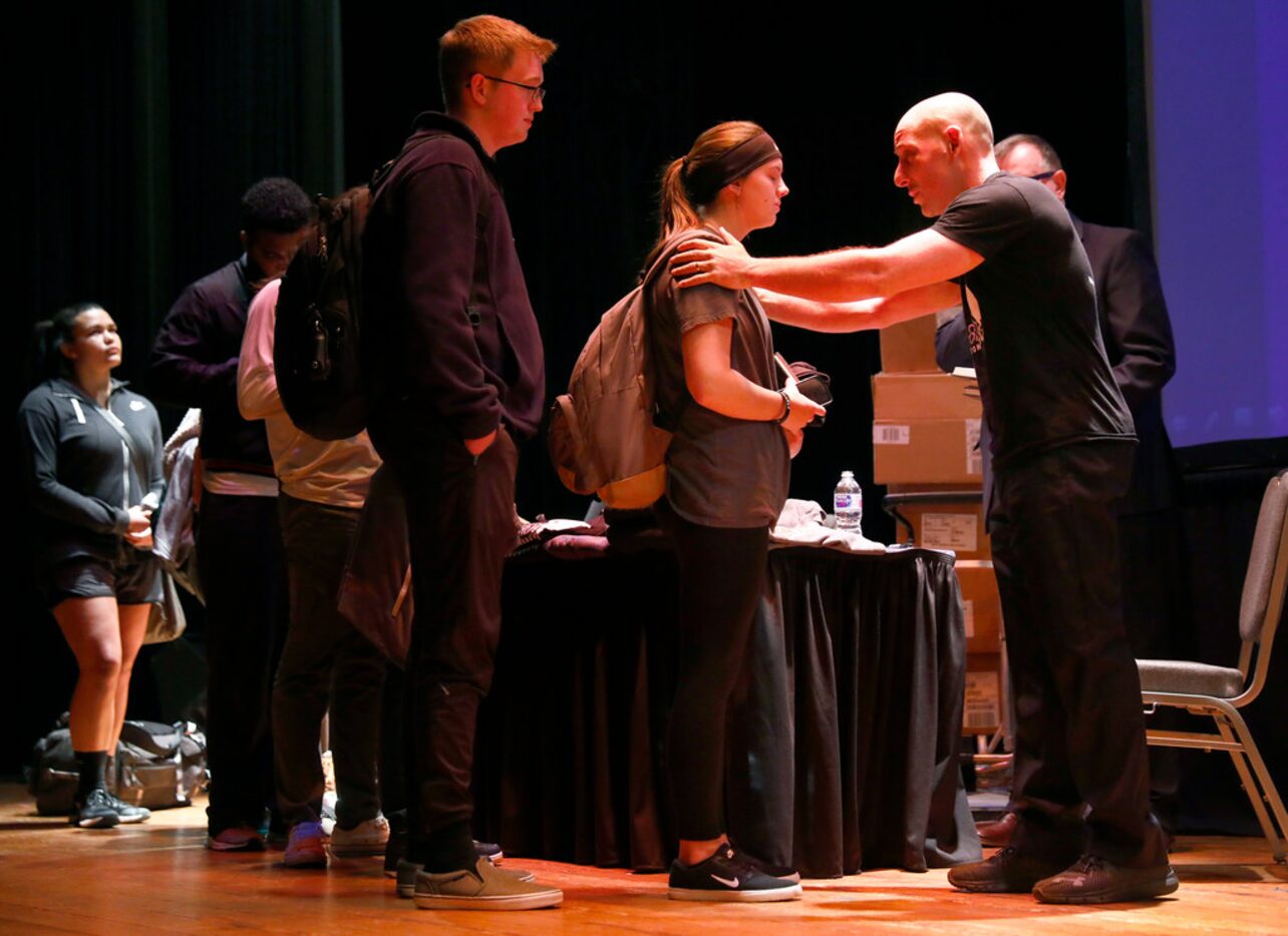 Suicide survivor, activist, storyteller and filmmaker Kevin Hines (right) comforts a student...