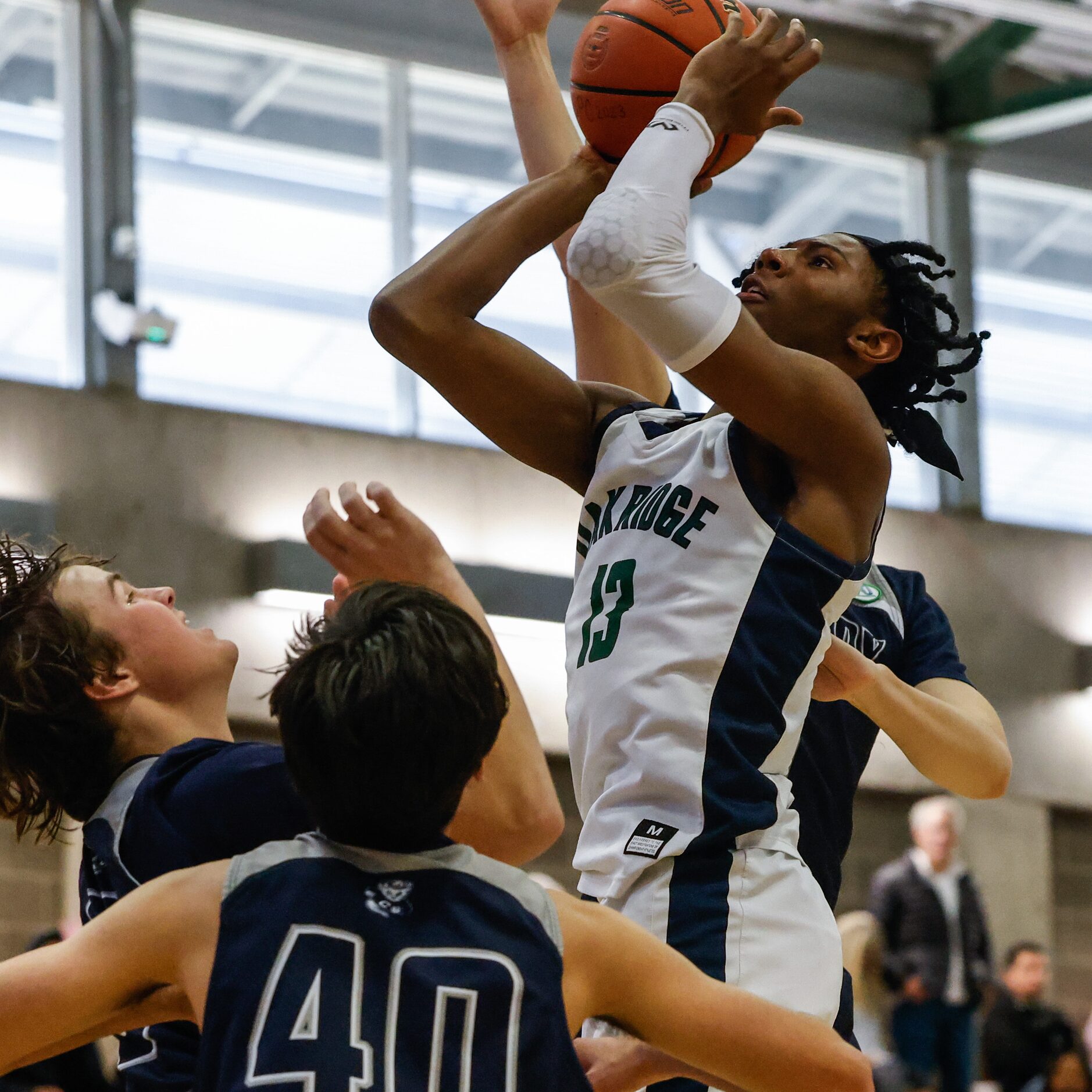 Oakridge Owls' Mitchell Holmes (13) goes for a shot against Casady Cyclones during the third...