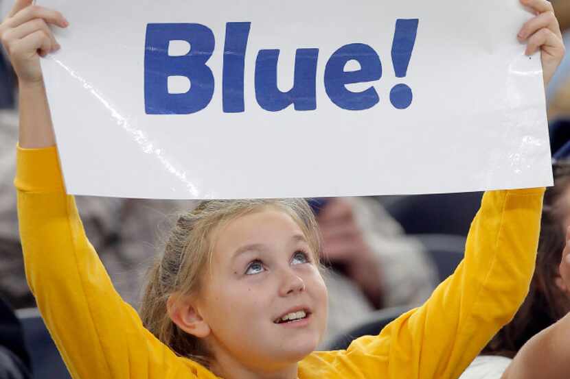 A young Highland Park fan cheers on her team during the first half of a UIL Class 5A...