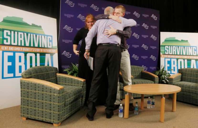 
Professor Perry Reeves (center) got a hug from Dr. Kent Brantly, at Abilene Christian...