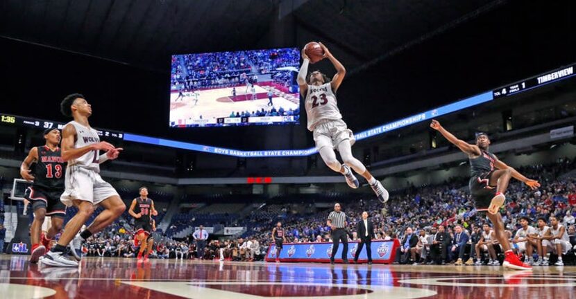 Timberview's Trazarien White #23 flies by defenders. UIL boys basketball 5A State semi-final...