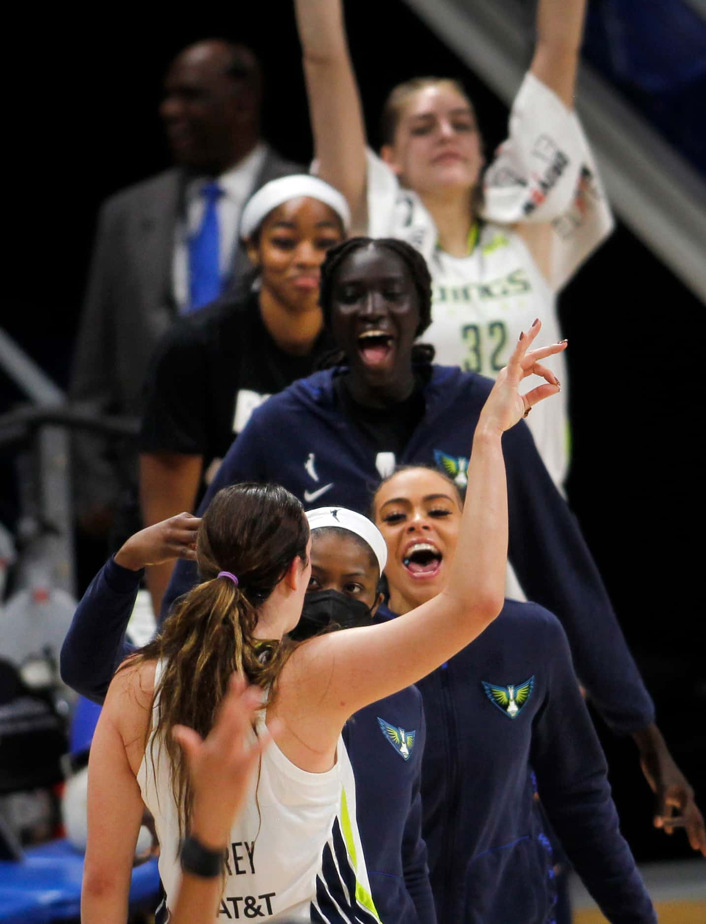 Dallas Wings guard Marina Mabrey (3, back to camera) gestures after sinking a 3-pointer and...