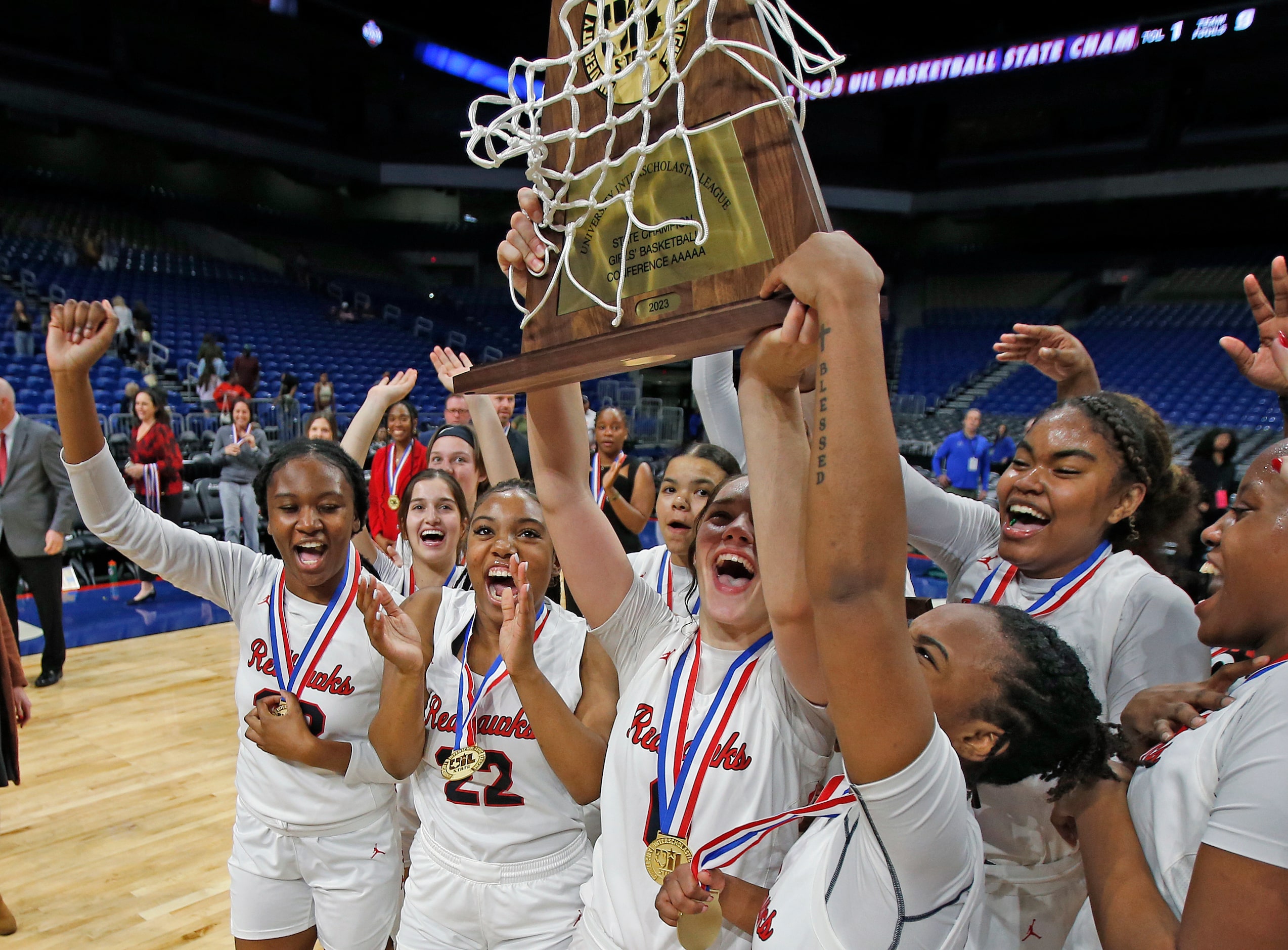 Frisco Liberty celebrates with their trophy after they defeated Lubbock Lubbock Cooper 57-52...