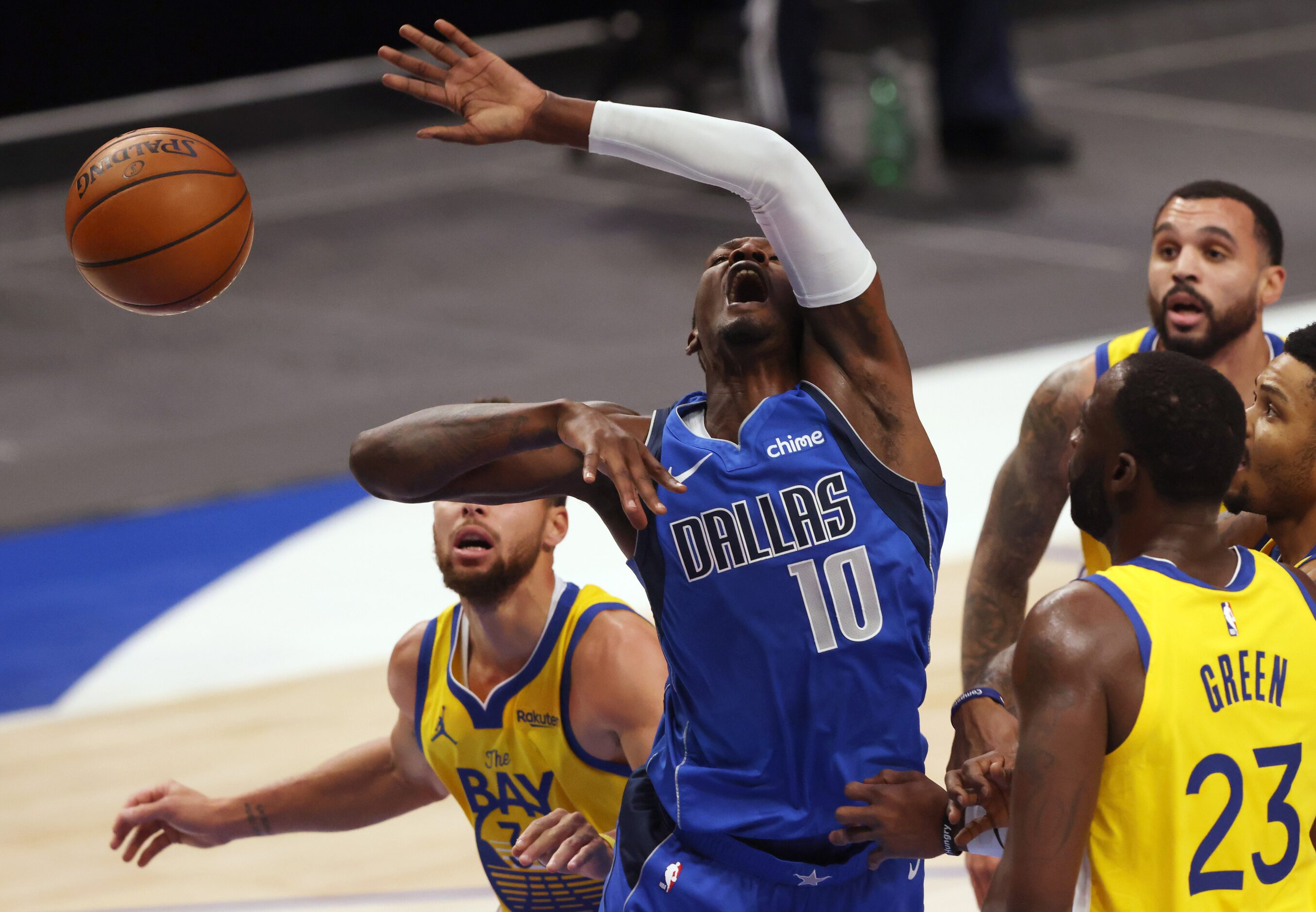 Dallas Mavericks forward Dorian Finney-Smith (10) is fouled by Golden State Warriors forward...