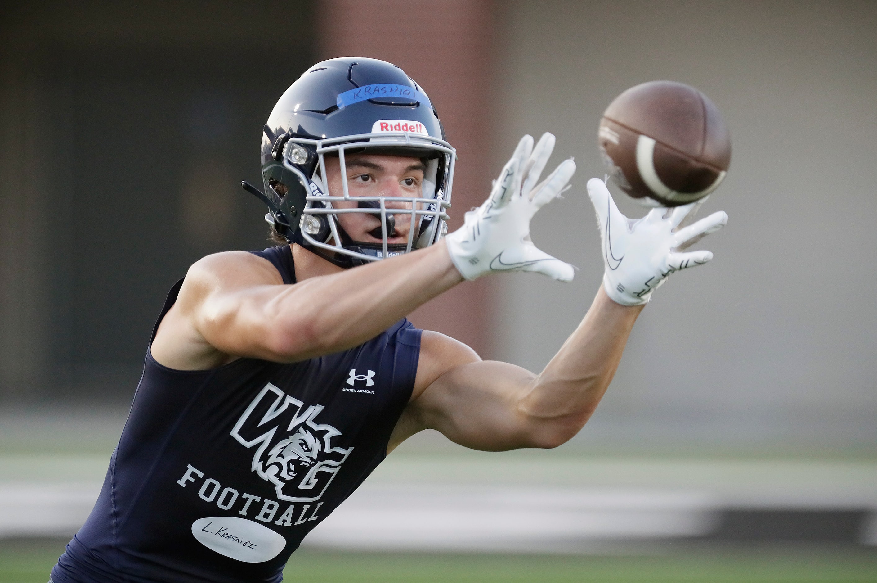 Wide receiver Leon Krasniqi, 16, makes a catch during drills as Walnut Grove High School...