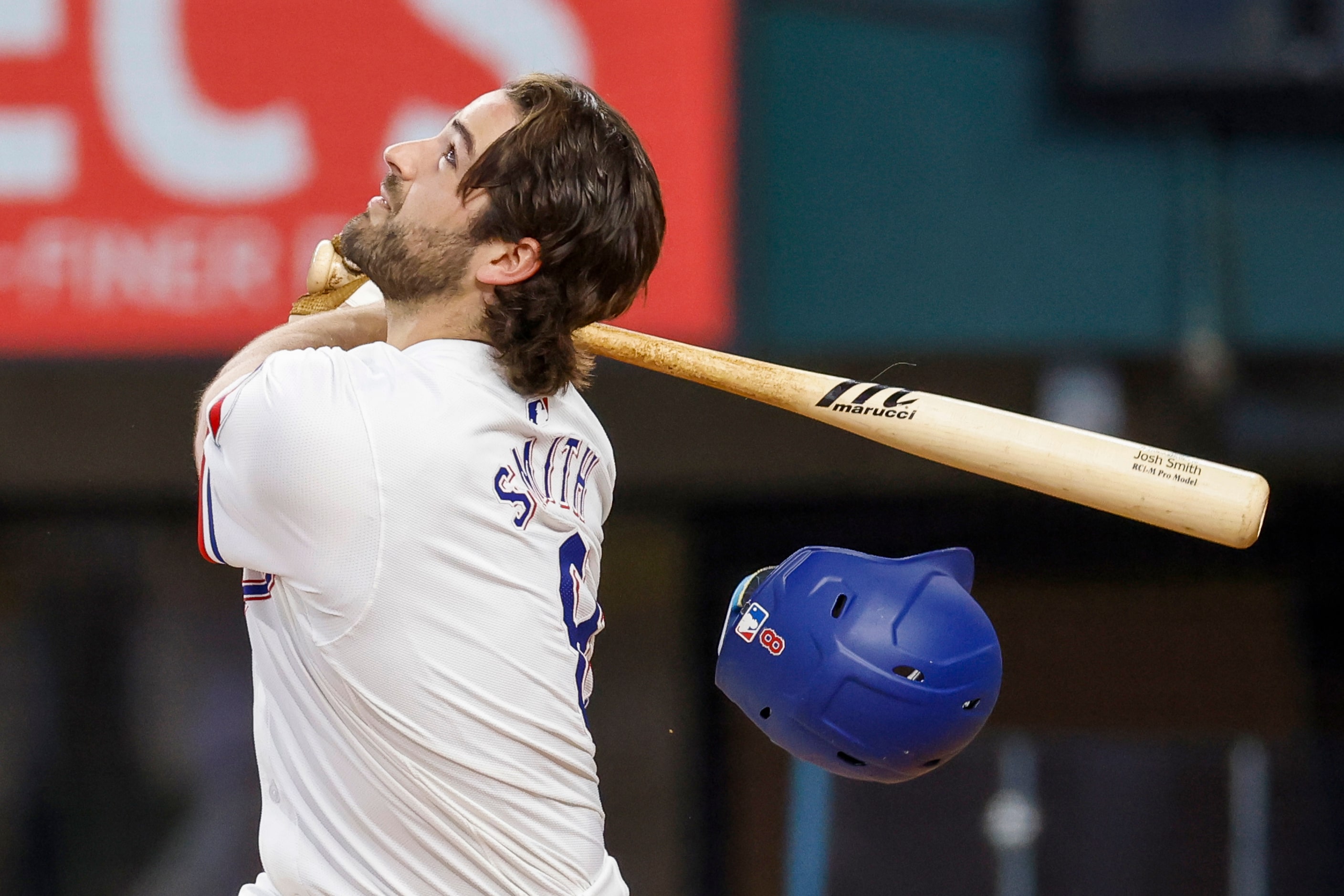 Texas Rangers third baseman Josh Smith (8) swings out of his helmet on a pop fly to first...