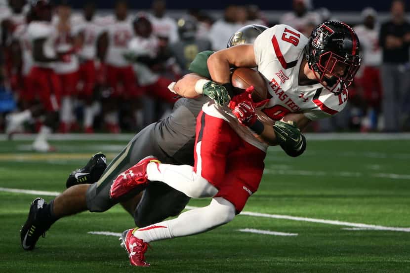 Texas Tech Red Raiders wide receiver Zach Austin (19) is tackled by Baylor Bears player in...