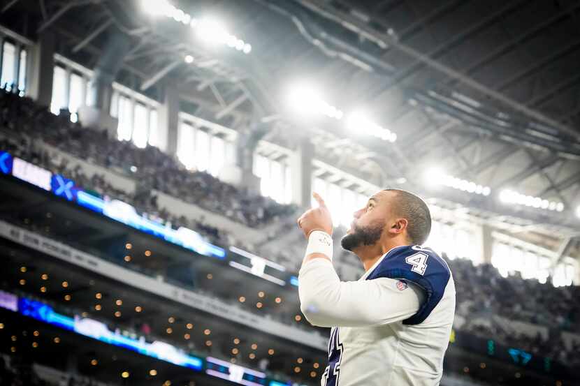 Dallas Cowboys quarterback Dak Prescott stands points skyward before an NFL football game...