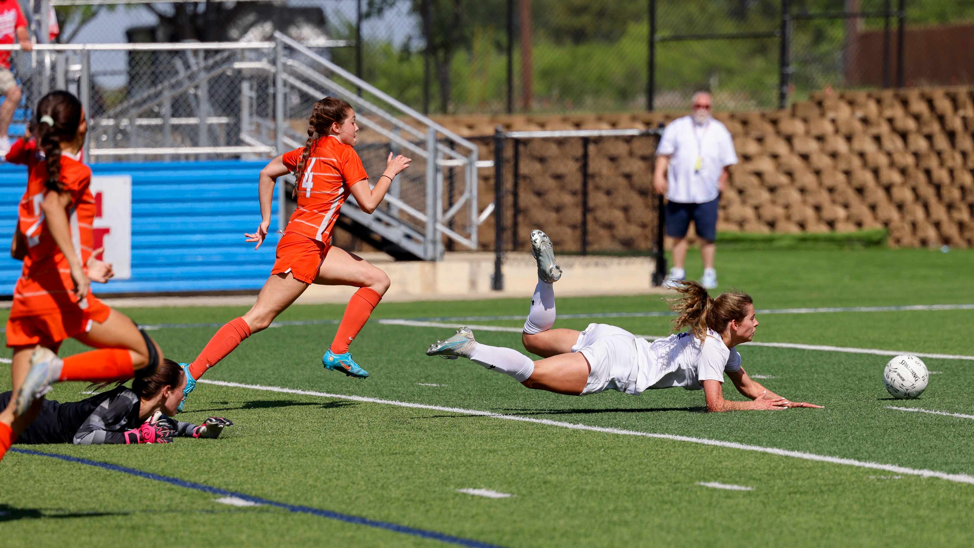 Midlothian Heritage midfielder Jules Burrows (3) falls to the ground after being tripped by...