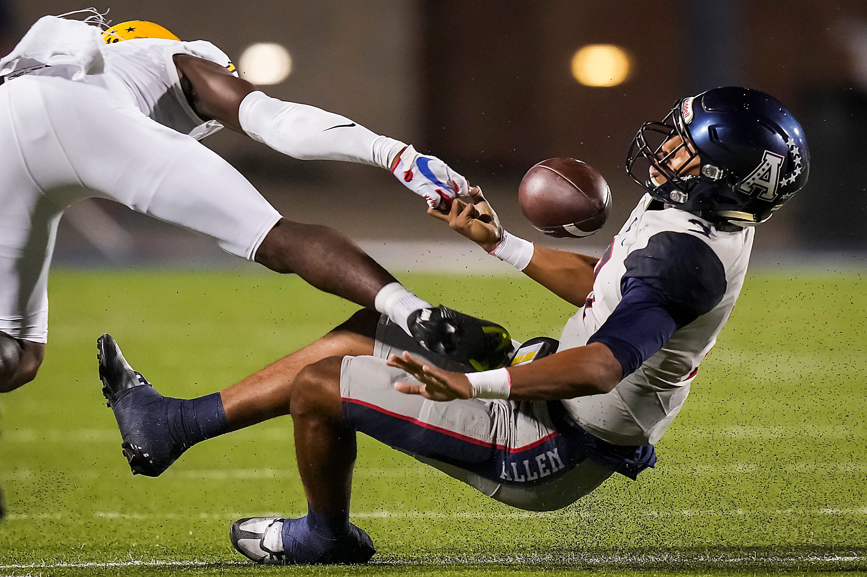 Allen quarterback Mike Hawkins (3) loses the football as he is dropped for a loss by...