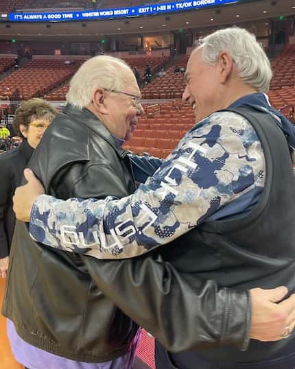 CBS Sports broadcaster Verne Lundquist and Dallas Cowboys radio voice Brad Sham share a hug...
