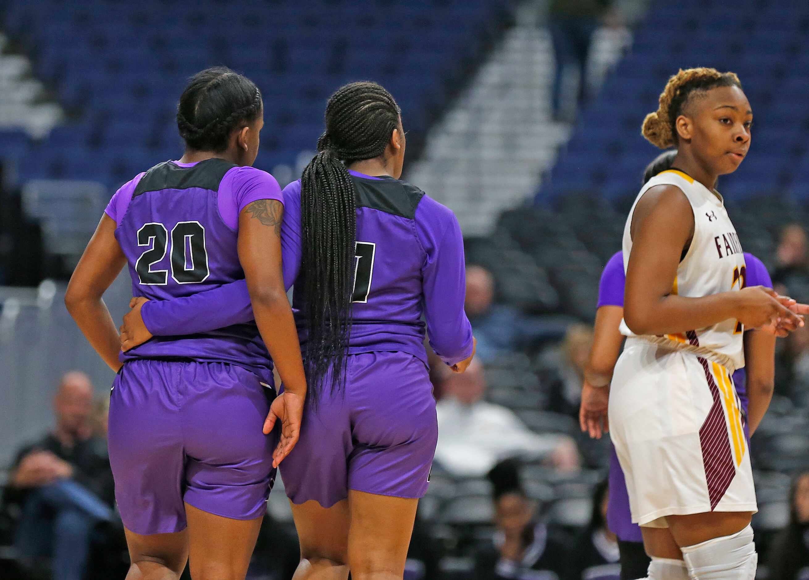 Lincoln guard Nakia Brumley (#20) is consoled by teammate Dallas Lincoln guard Alexis Brown...