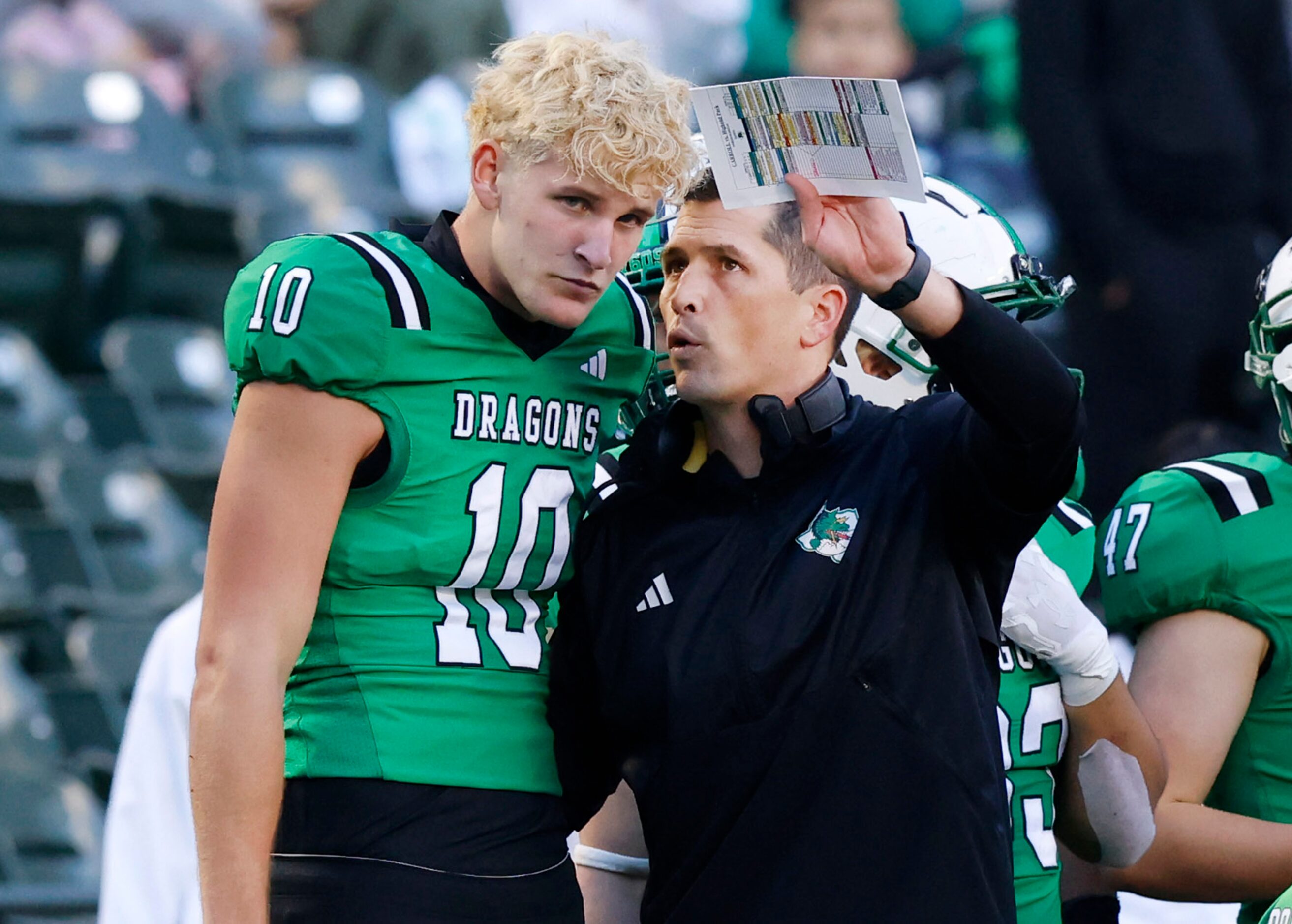 Southlake Carroll head coach Riley Dodge confers with his quarterback Graham Knowles (10)...