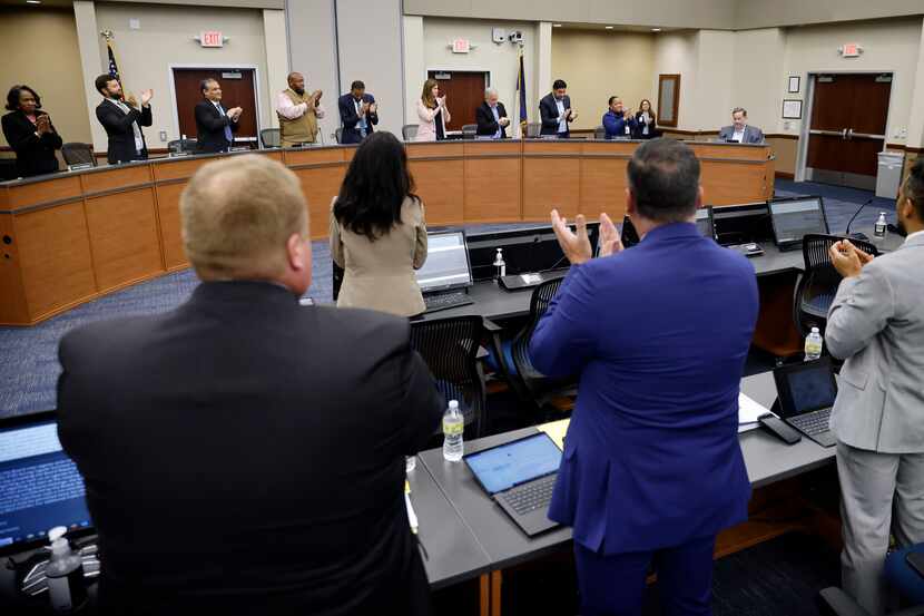 Members of the Dallas ISD board give a standing ovation for District 2’s Dustin Marshall...