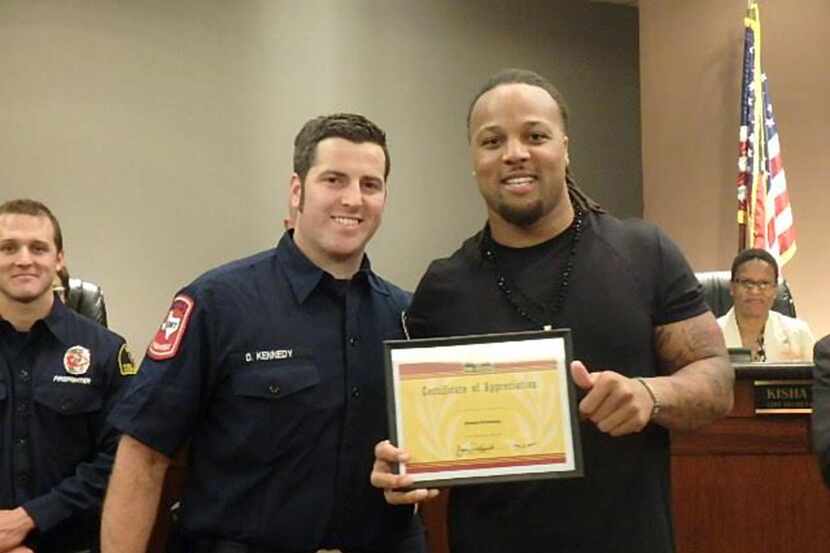 
Wendell Williams (right) presented firefighter and paramedic Daniel Kennedy (left) and the...